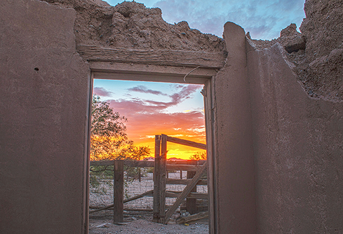 Adobe archway facing sunset in Florence, AZ (image)